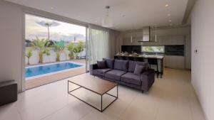 a kitchen and living room with a couch and a table at City Napa Seaview Villas - Villa 4 in Ayia Napa