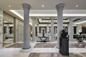 a lobby with columns and a table in a building at TITANIC Gendarmenmarkt Berlin in Berlin