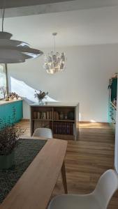 a living room with a wooden table and chairs at Casa Reggiana in Reggio Emilia