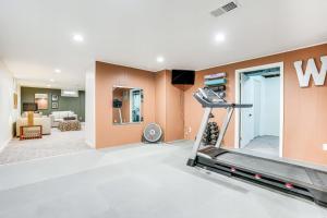 a gym with a treadmill and a living room at Wicks Home - Desirable Neighborhood Near Downtown home in Kalamazoo