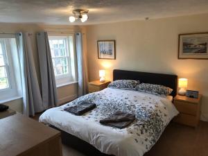 a bedroom with a bed with two towels on it at 5 Bed in Glasson 36969 