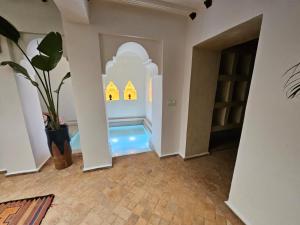 a room with a pool in the middle of a house at Riad - La Perle d'Orane - Marrakech- Medina-Rooftop in Marrakesh