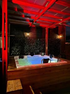 bañera de hidromasaje en una habitación con luces rojas en Hermosa casa de campo el Peñol,Guatapé, en Guatapé