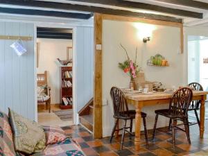 a dining room with a wooden table and chairs at Gerlan (no. 4, Station Rd) in Tregaron