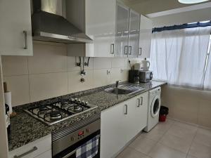 a kitchen with a sink and a stove top oven at Bolina 1 Historic Center Cascais in Cascais