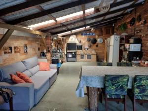 a living room with a couch and a table at Pousada Rancho 60 in Balneário Camboriú
