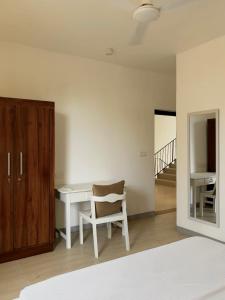 a bedroom with a desk and a chair and a staircase at Sea Esta Villa Mount Lavania in Ratmalana