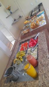 a counter top with a bunch of food on it at Hotel Rio Center in Juazeiro