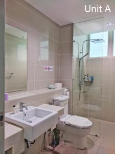 a bathroom with a sink and a toilet and a shower at JC Suites @ Sutera Avenue in Kota Kinabalu