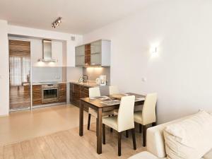 a kitchen and dining room with a table and chairs at visit baltic - Platan in Świnoujście