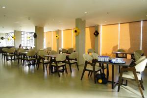 a restaurant with tables and chairs in a room at Regenta Resort Vindhyachal, Statue of Unity in Kevadia