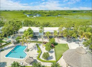 an aerial view of a resort with a swimming pool at Overlooking Marina/Ocean view & FREE GOLF CART in Key Largo