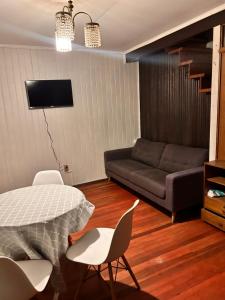 a living room with a bed and a couch at Casa familiar in Temuco