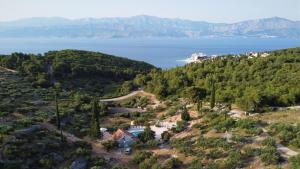 an aerial view of a house on a hill near the water at Villa Broč in Postira
