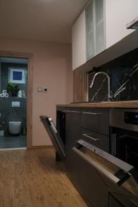 a kitchen with a sink and a stove at Villa Broč in Postira