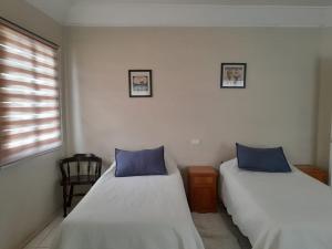 Кровать или кровати в номере Hotel Palermo Quintero