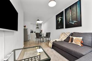 a living room with a couch and a table at 1 Bedroom Apartment- Finsbury Park Station (D) in London