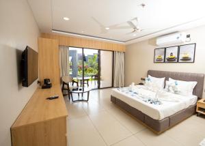 a hotel room with a bed and a television at Regenta Resort Vindhyachal, Statue of Unity in Kevadia
