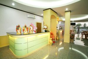 a lobby with a counter with chinese figurines on it at Soda Resort in Kamphaeng Phet