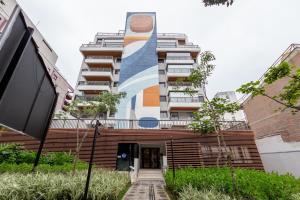 a building with a mural on the side of it at BHomy Medeiros in Sao Paulo +22 photos