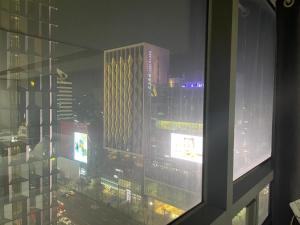 a view of a city at night from a window at Serein_HongDae in Seoul