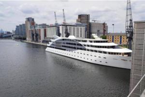 a large cruise ship in the water in a city at Gresham House - London Excel in London