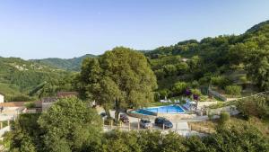 a view of a resort with a swimming pool at Arcaloro Resort Rooms Ghiro in SantʼAngelo di Brolo