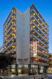 an office building with a sign in front of it at Dave Red Athens, a member of Brown Hotels in Athens