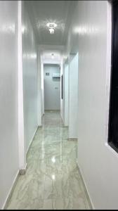 un pasillo con paredes blancas y una puerta blanca en 1bedroom serviced apartment in Benin City, en Benin City