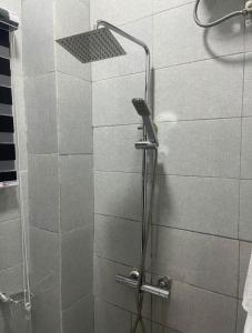 a shower with a glass door in a bathroom at 1bedroom serviced apartment in Benin City in Benin City