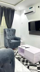 a living room with a chair and a coffee table at 1bedroom serviced apartment in Benin City in Benin City
