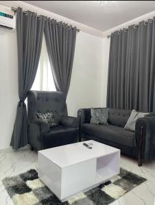 a living room with a couch and a coffee table at 1bedroom serviced apartment in Benin City in Benin City