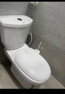 a bathroom with a white toilet in a stall at 1bedroom serviced apartment in Benin City in Benin City