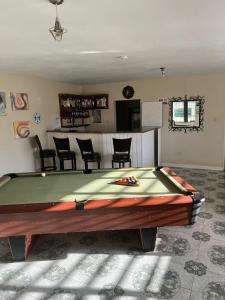 a pool table in a living room with at Retreat Guest House in Falmouth