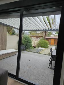a sliding glass door with a view of a patio at Maison typique bordelaise in Bordeaux +3 photos