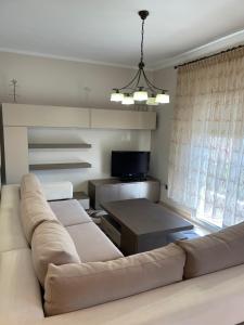 a living room with a couch and a tv at Guest house GN in Naousa