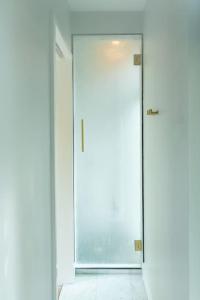 una puerta abierta en una habitación con paredes blancas en The Sea Containers, en Index