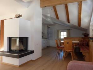 a living room with a fireplace and a dining room at Haus Jäger in Filzmoos