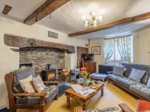 a living room with a stone fireplace and couches at 9 Bed in Welshpool 40870 in Llanfyllin