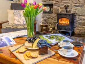 a coffee table with a tray of food and a fireplace at 9 Bed in Welshpool 40870 in Llanfyllin