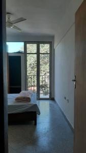 a bedroom with a bed and a large window at Departamento céntrico in San Lorenzo