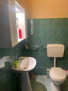 a bathroom with a toilet and a sink at B&B St. Peter's Suites in Rome