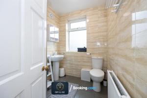 a bathroom with a toilet and a sink at Luxurious & Spacious 2 Bedroom Home By Opuluxe Properties Short Lets & Serviced Accommodation Near Manchester City Center in Manchester