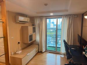 a room with a large window and a room with a desk at 2bd Apartment near icon Siam close to Everything in Bangkok