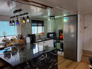 a kitchen with a counter top and a refrigerator at JASMINE CORAL JAY Boutique Boatel Ocean Village in Gibraltar
