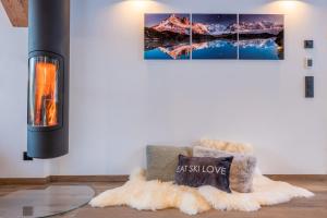 a fireplace in a living room with a fuzzy rug at Chalet Seven Summits - Pool - Sauna - Jacuzzi in Chamonix-Mont-Blanc