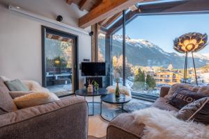 a living room with a view of a mountain at Chalet Seven Summits - Pool - Sauna - Jacuzzi - By Cozee Rentals in Chamonix-Mont-Blanc
