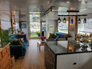 a kitchen and living room with couches and a counter at JASMINE CORAL JAY Boutique Boatel Ocean Village in Gibraltar