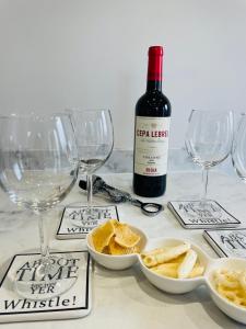 a bottle of wine and wine glasses on a table at Cragside in Callander +13 photos