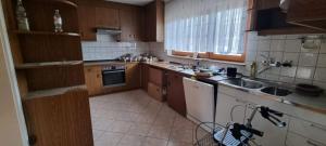 a kitchen with wooden cabinets and white appliances at Haus - Baden-Baden - 8x Zimmer in Sandweier